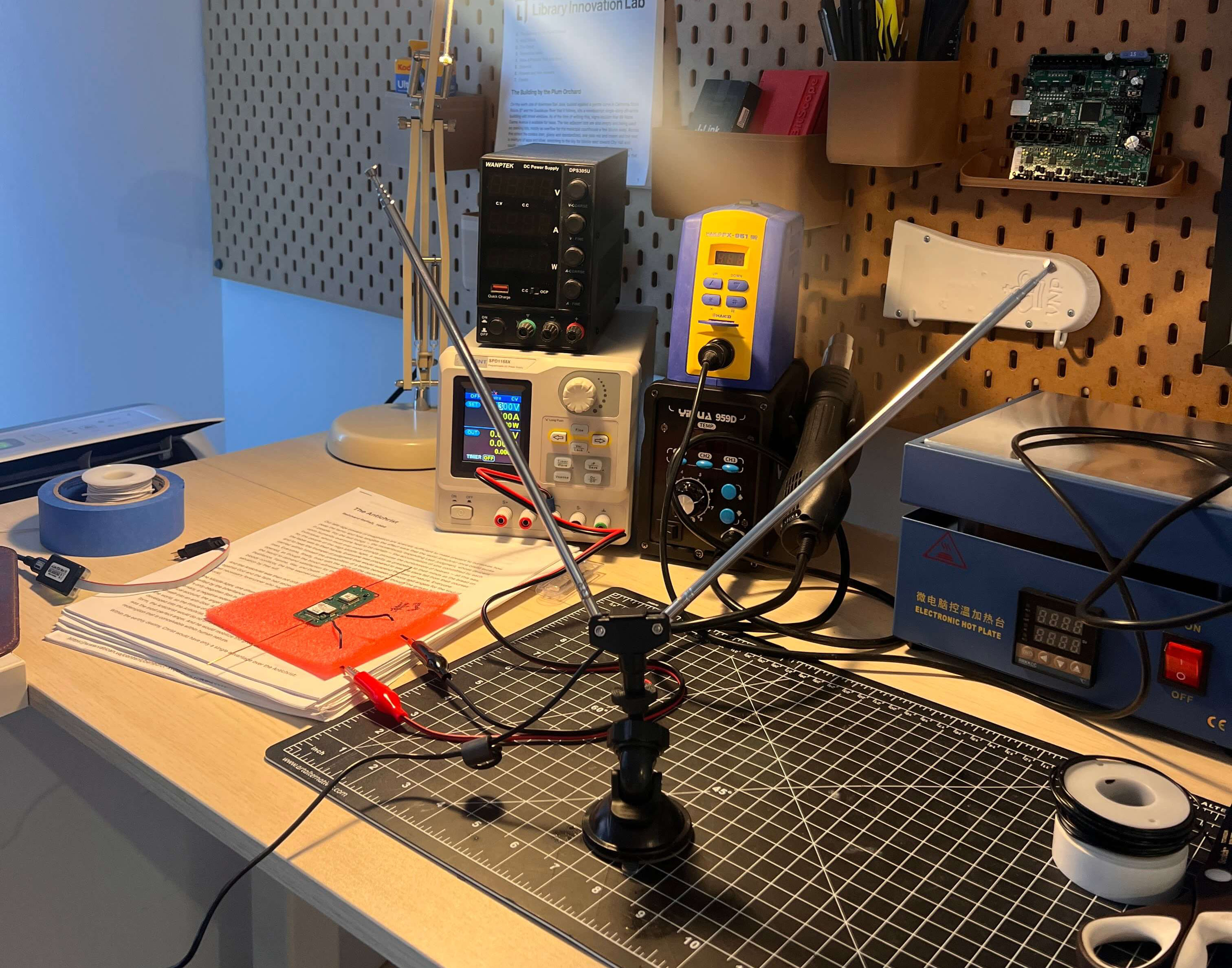 A Stratolink board, bench supplies, and SDR antennas on the electronics workbench.